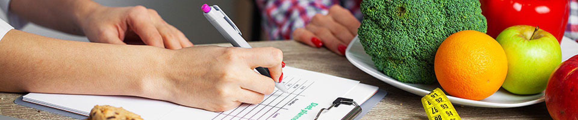 Nutritionist prepares a diet plan for an overweight woman.